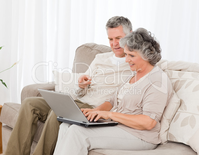 Retired lovers looking at their laptop