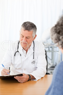 A senior doctor talking with his patient