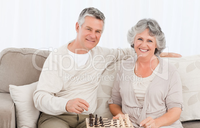 Senior couple looking at the camera at home