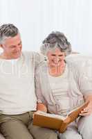 Senior couple looking at their photo album