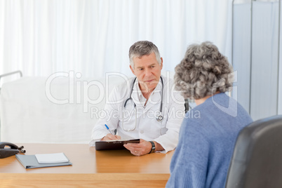 A senior doctor talking with his patient