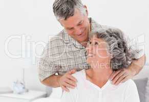 Retired man giving a massage to his wife