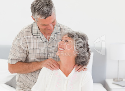 Retired man giving a massage to his wife