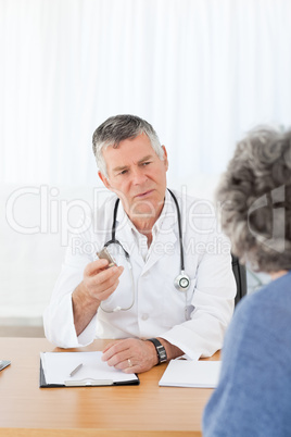 A senior doctor talking with his patient