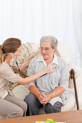 Nurse taking the heartbeat of her patient