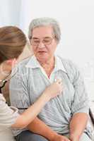 Nurse taking the heartbeat of her patient