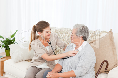 Nurse taking the heartbeat of her patient