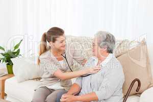 Nurse taking the heartbeat of her patient