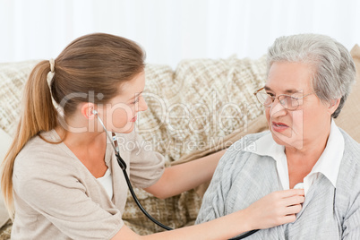 Nurse taking the heartbeat of her patient