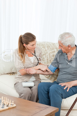 Lovely nurse helping her patient to do exercises