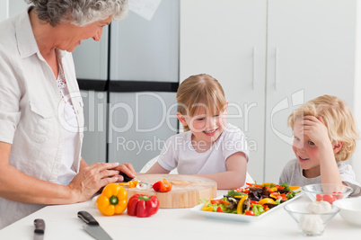 Children cooking with their grandmother