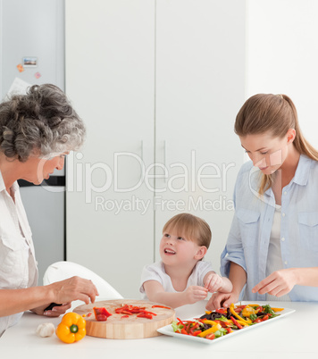 Family cooking together in the kitchen at home