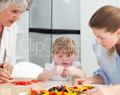 Family cooking together in the kitchen at home