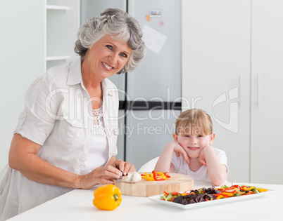 Lovely girl and her grandmother looking at the camera