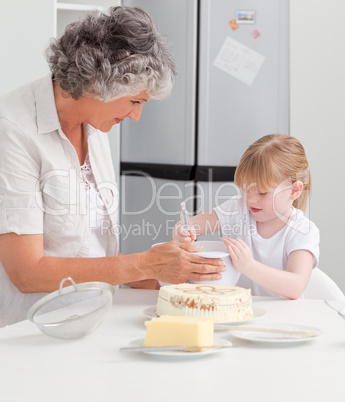 Girl baking with her grandmother at home