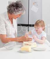 Girl baking with her grandmother at home