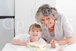 Lovely girl and her grandmother looking at the camera