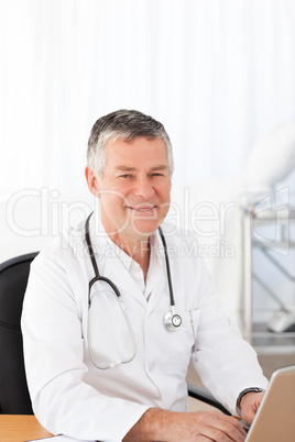 A senior doctor in his office
