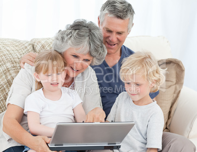 Adorable family looking at the laptop