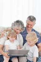 Adorable family looking at the laptop