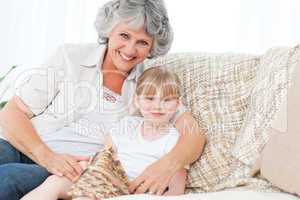 Grandmother helping her little girl to knit