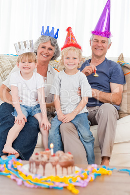 Happy family looking at the camera on a birthday