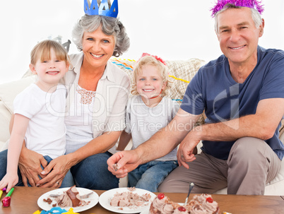 Happy family looking at the camera on a birthday