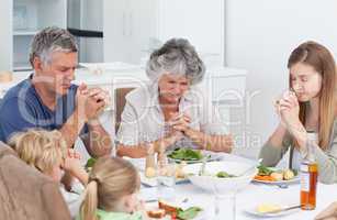Family praying at the table