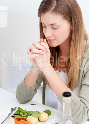 Woman praying at the table