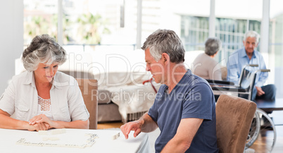 Couple playing dominos
