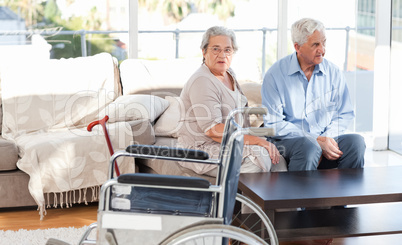 Lovely retired couple talking on the sofa