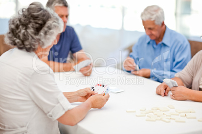 Retired people playing cards together