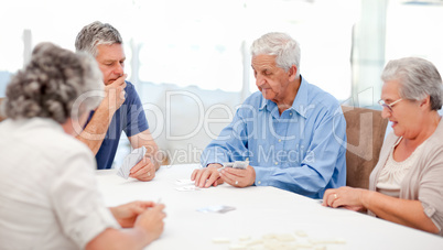 Retired people playing cards together