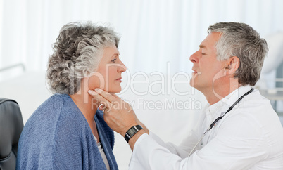 A senior doctor doing an examination of his patient A senior doctor doing an examination of his patient