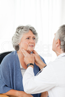 A senior doctor doing an examination of his patient