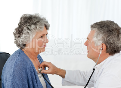 A senior doctor doing an examination of his patient