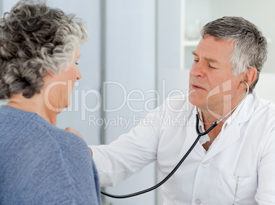 A senior doctor doing an examination of his patient