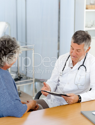 A senior doctor with his patient in his office