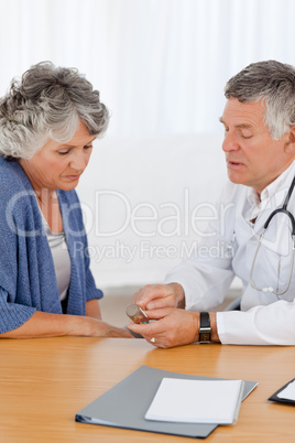 A senior doctor with his patient in his office