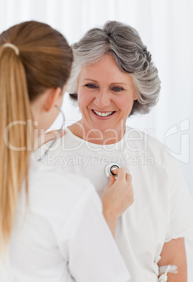 Nurse taking the heartbeat of her patient