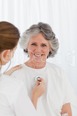 Nurse taking the heartbeat of her patient