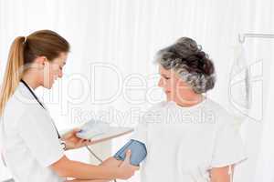 Nurse taking the blood pressure of her patient