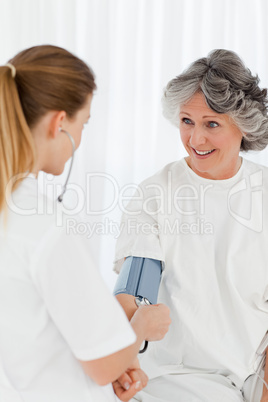 Nurse taking the blood pressure of her patient