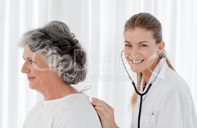 Pretty nurse taking the heartbeat of her patient
