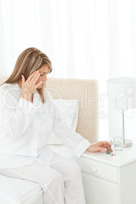 Woman having a headache on her bed
