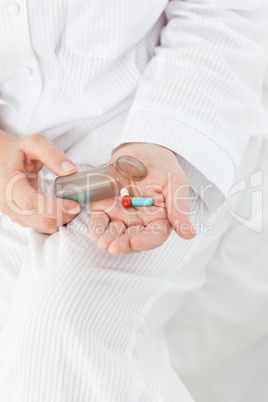 Sick woman taking her pills at home