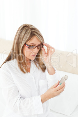 Sick woman taking her pills at home