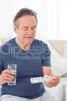 Sick man taking his pills