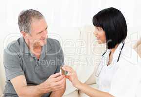 Nurse showing pills to her mature patient