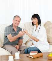 Retired man with his nurse looking at the camera